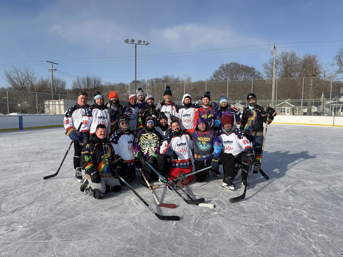 16-Bit Legends team posing on an outdoor pond rink in their custom jerseys