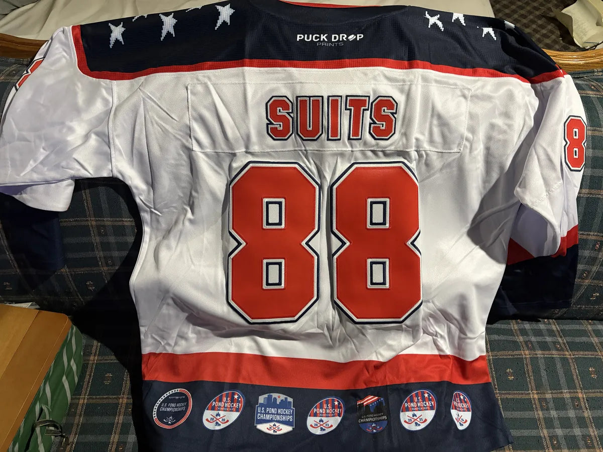 Back of a white 16-Bit Legends jersey with SUITS and number 88