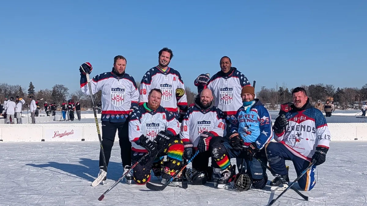 16-Bit Legends team photo on outdoor ice in front of a tournament banner