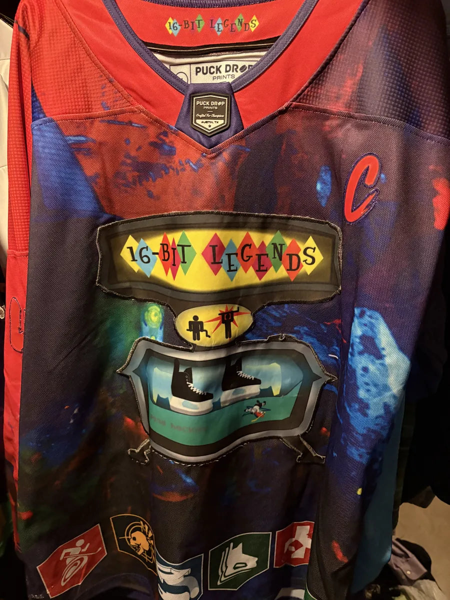 Close-up of a dark 16-Bit Legends custom jersey with pixel art graphics
